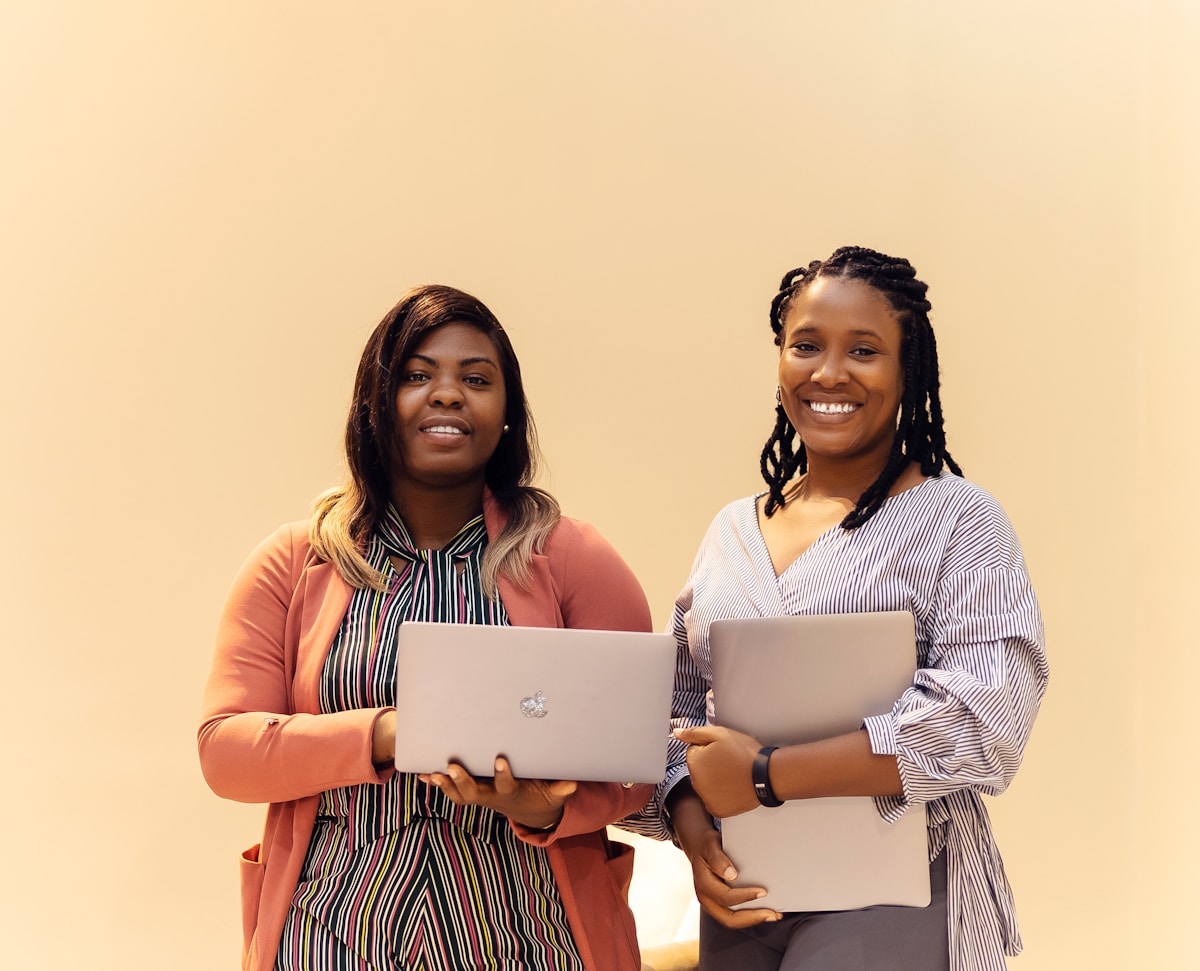African women learning IT support with laptops